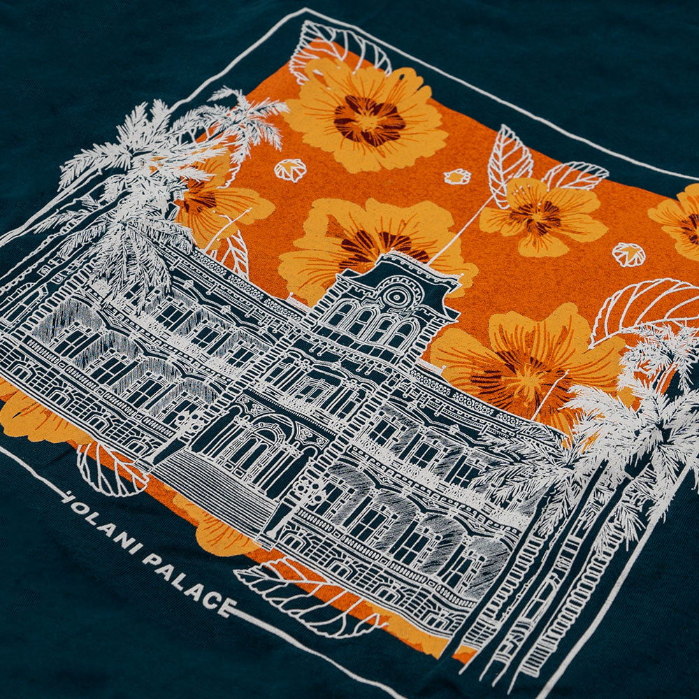 A t-shirt adorned with a sketch of a building complemented by blooming flowers.