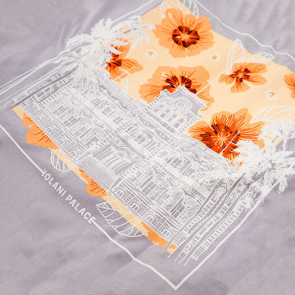 T-shirt featuring an illustration of a building surrounded by colorful flowers