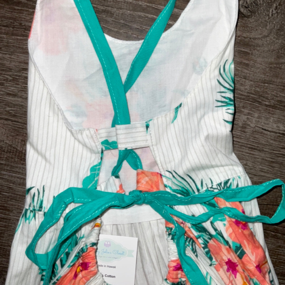 Back view of the dress highlighting adjustable turquoise crisscross straps and tie-back detail, designed for comfort, style, and a perfect fit every time.