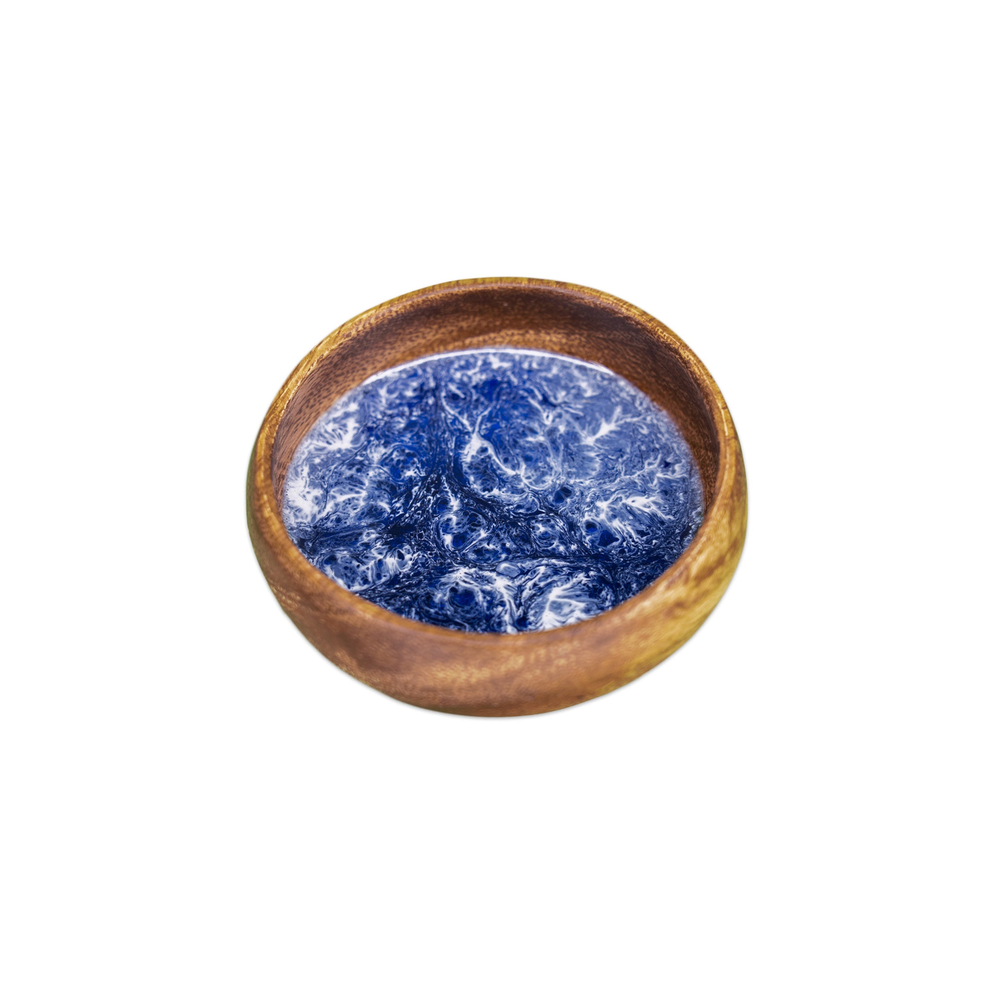 Handcrafted wooden bowl with a deep, glossy ocean-blue and white resin inlay, creating a swirling, wave-like pattern inside the bowl.