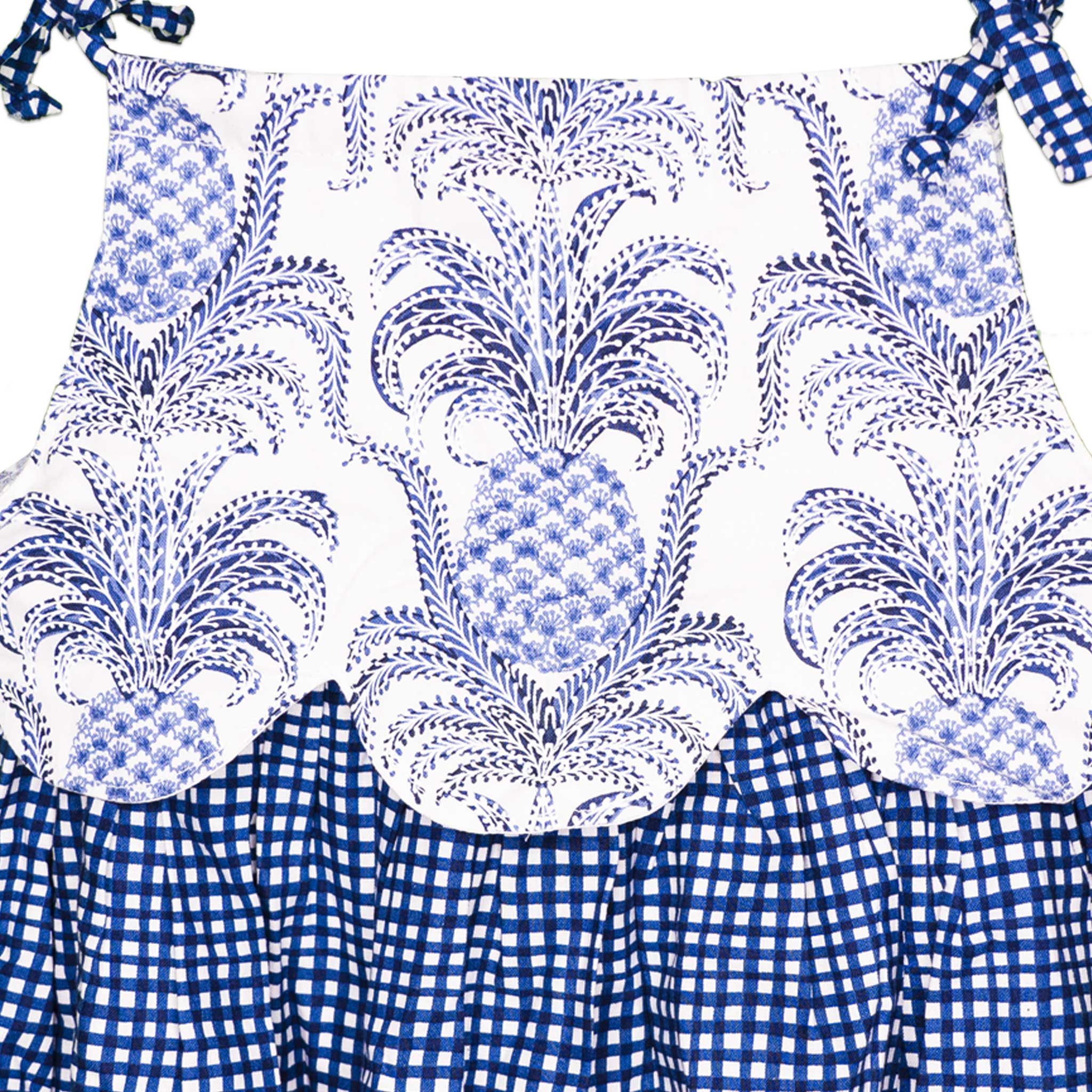 Detailed view of the Pineapple & Blue Plaid Scalloped Handmade Slip-On Dress’s bodice, highlighting the intricate pineapple print, scalloped edge, and gingham ribbon tie straps - a handcrafted piece bursting with personality and charm.