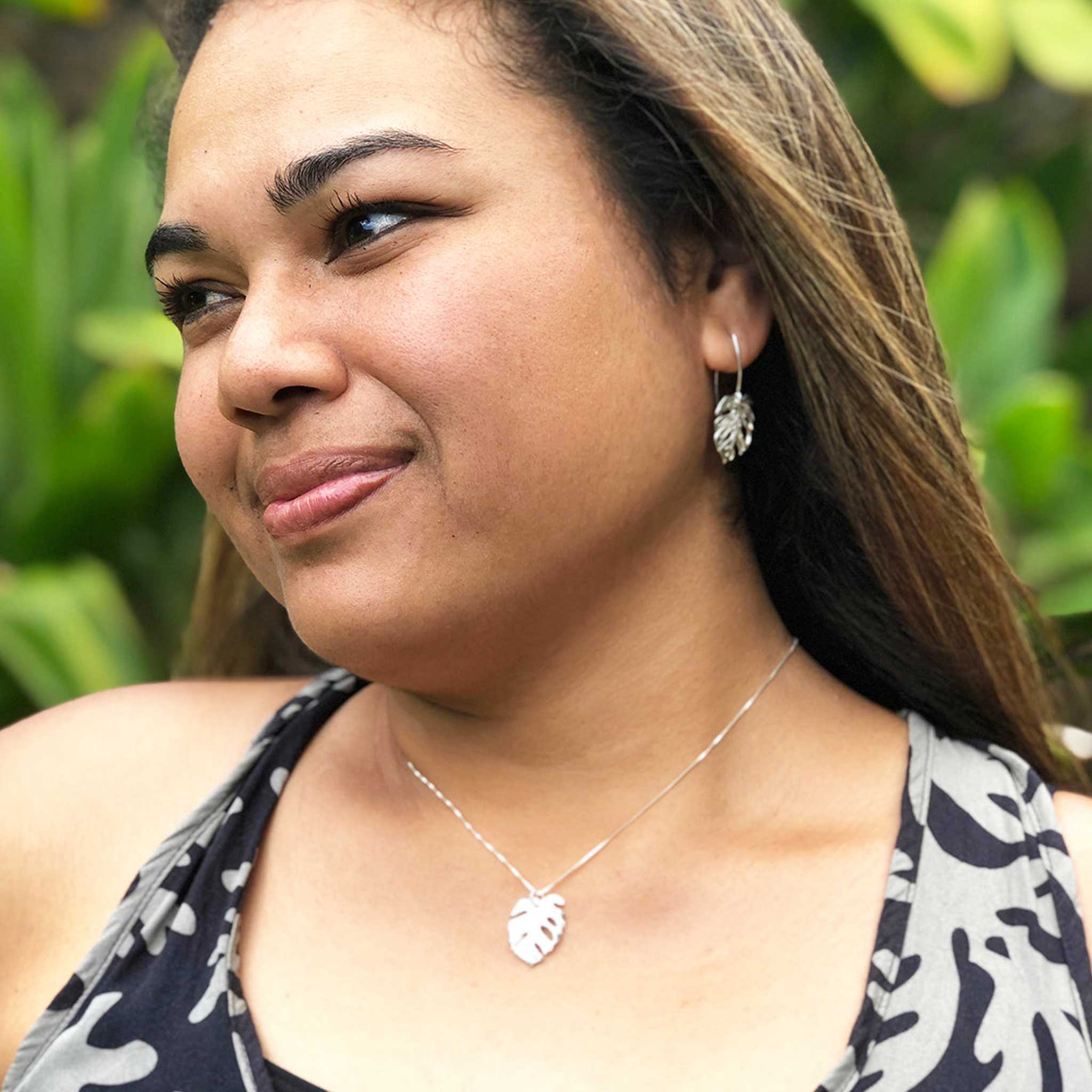 Tropical-inspired monstera leaf necklace in radiant sterling silver, worn beautifully in a lush garden setting, your go-to piece for natural elegance and everyday luxury