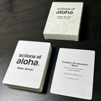 Actions of Aloha cards and box on a dark surface