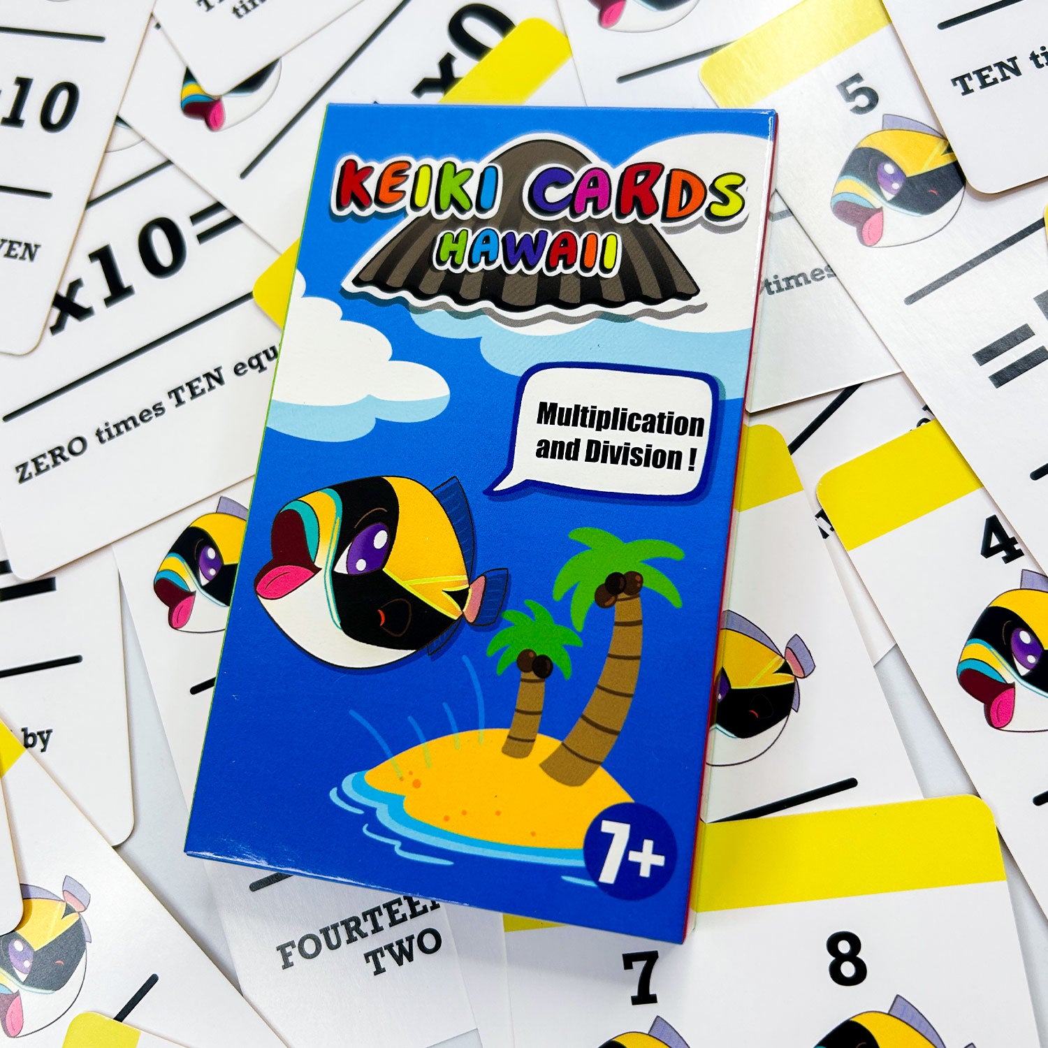 Keiki Cards Hawaii multiplication and division educational card set on a background of additional cards.