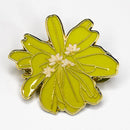 Green flower-shaped pin with gold accents on a white background