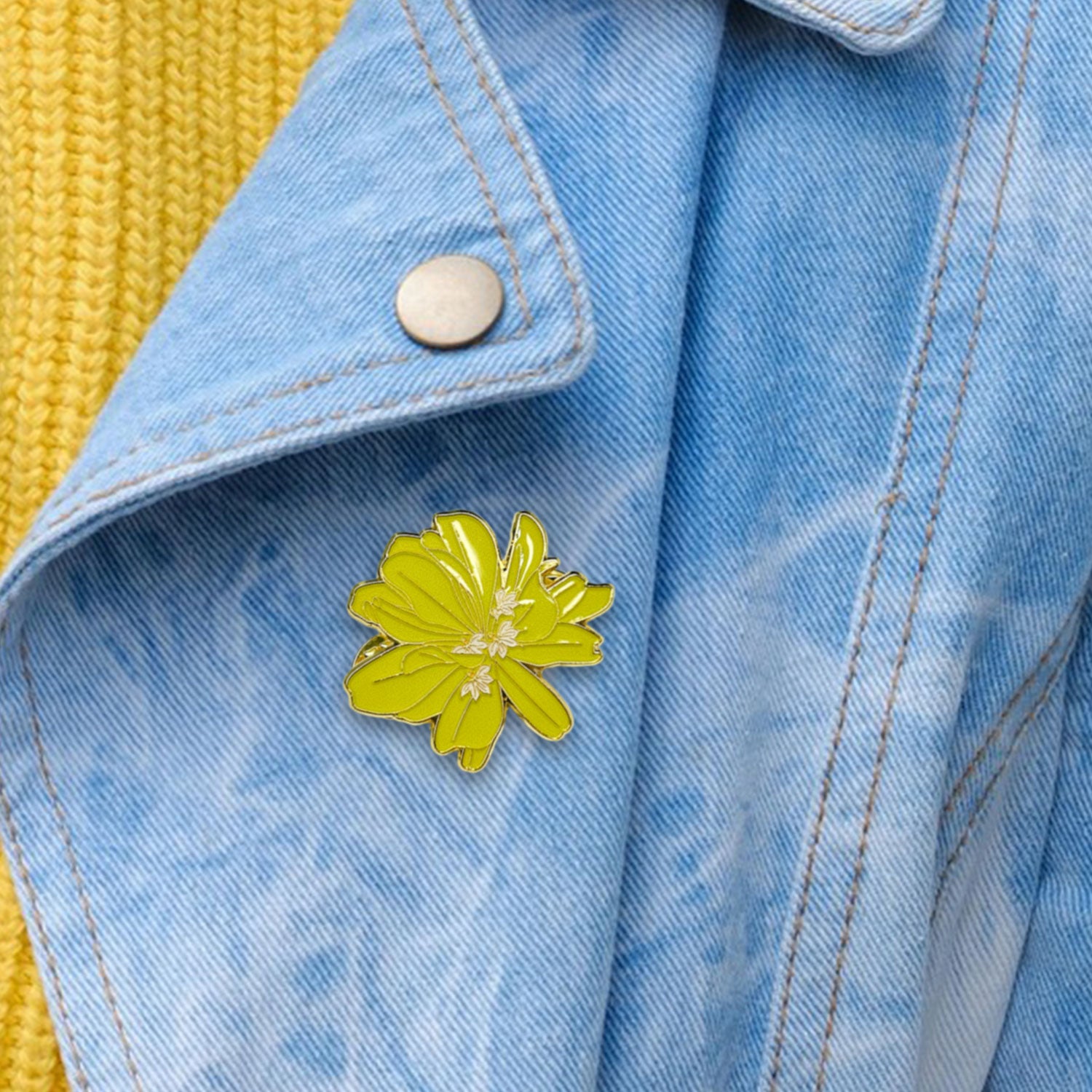Yellow flower pin on a blue denim jacket