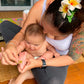 Applying calming oil to baby's foot